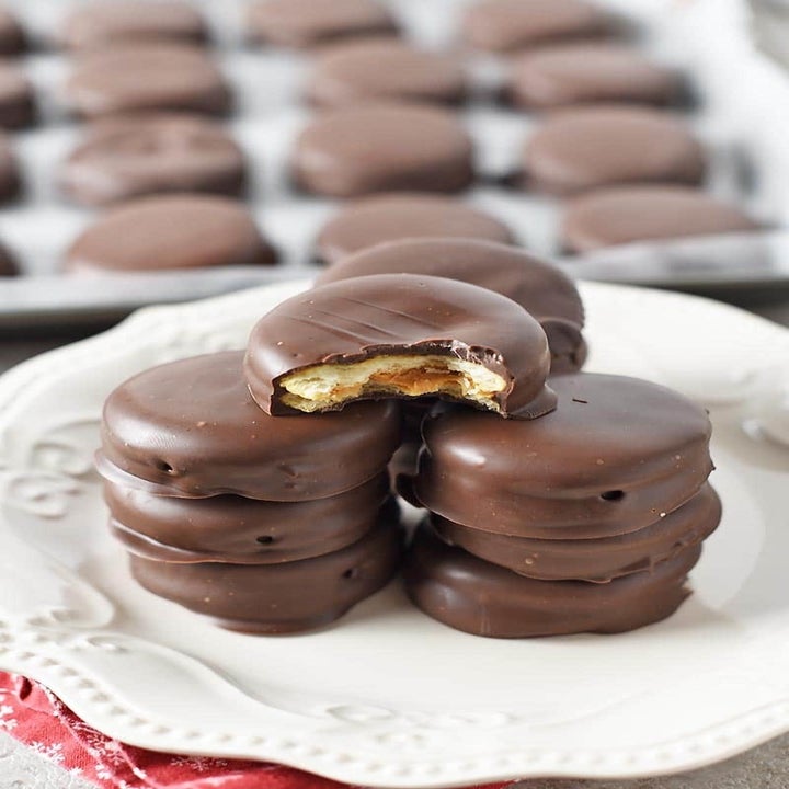 A stack of chocolate covered peanut butter Ritz cracker sandwich cookies.