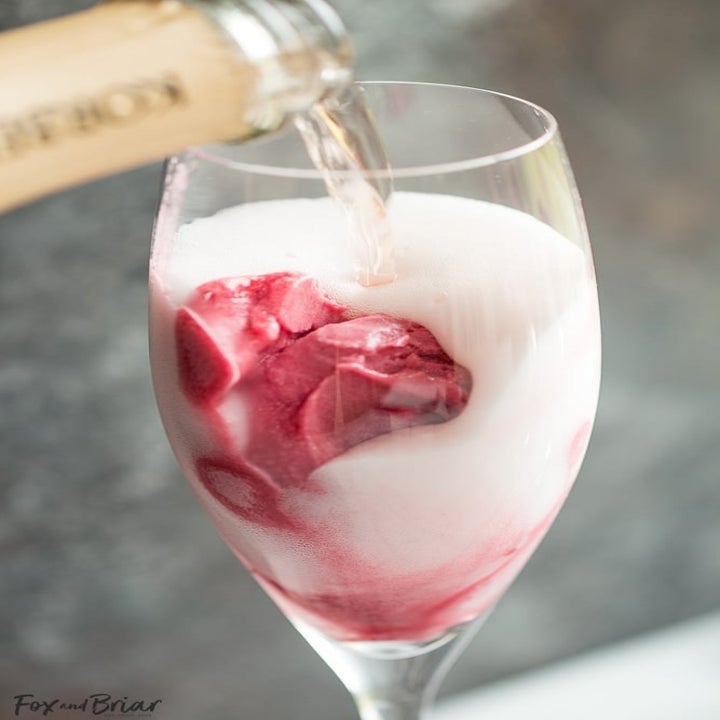 Pouring sparkling wine on top of sorbet in a Champagne glass.