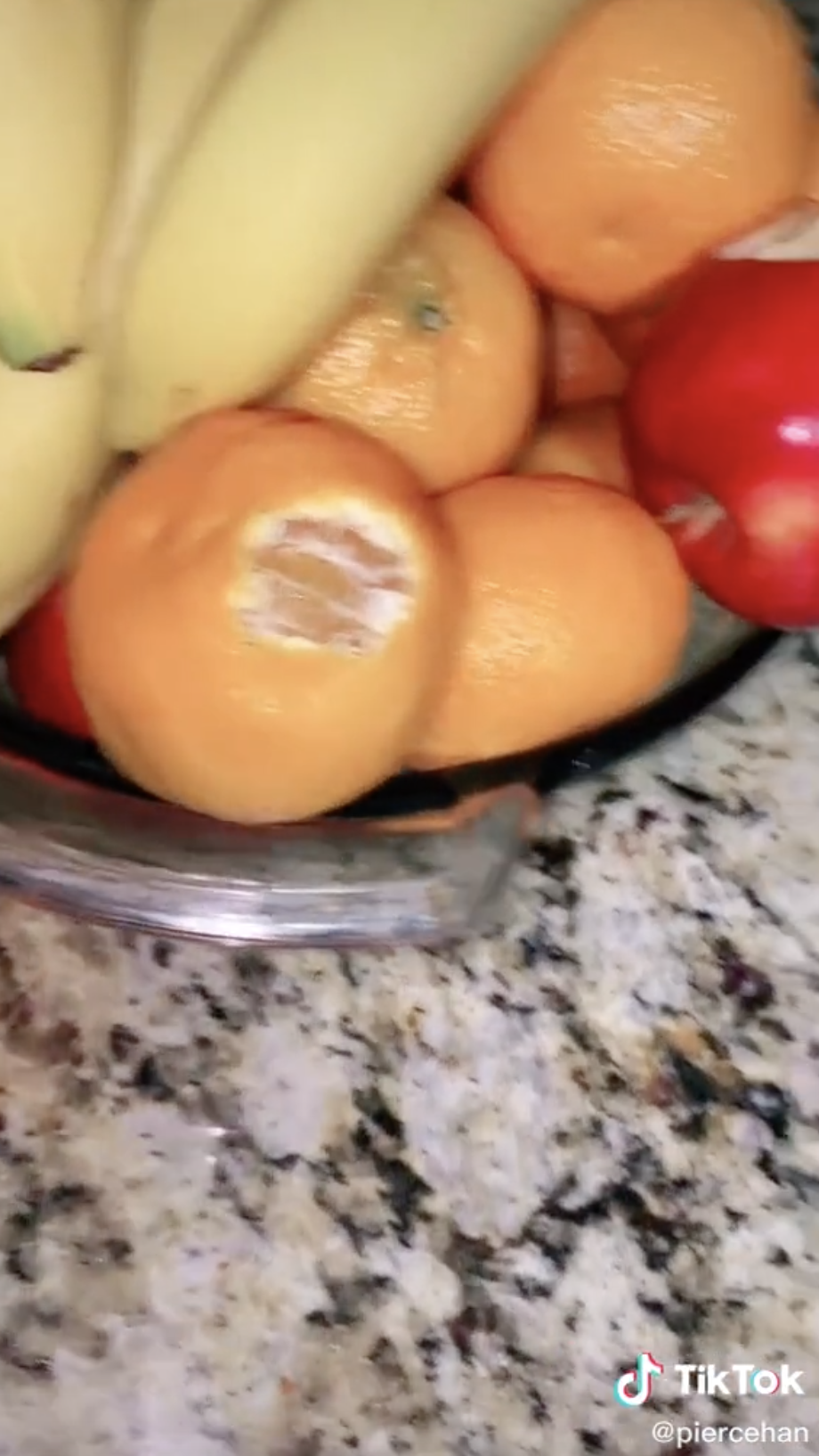 Orange and apple with kid&#x27;s bite marks.