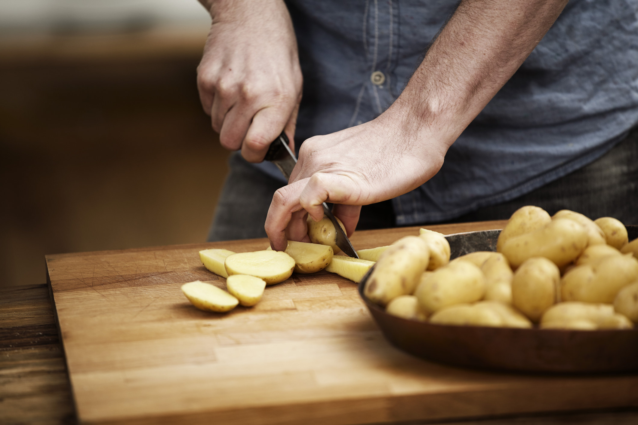 hand cutting potatoes