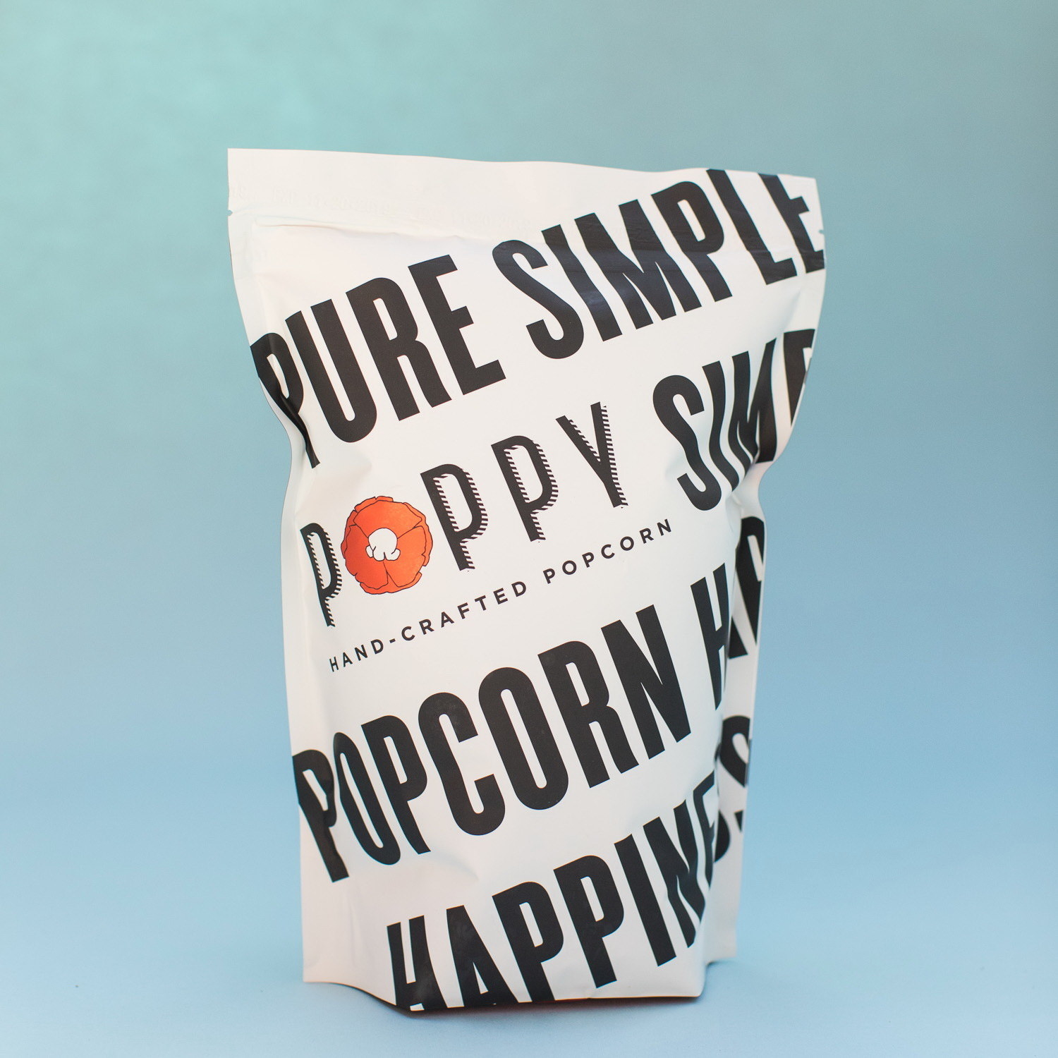 white bag with ziploc that says poppy popcorn