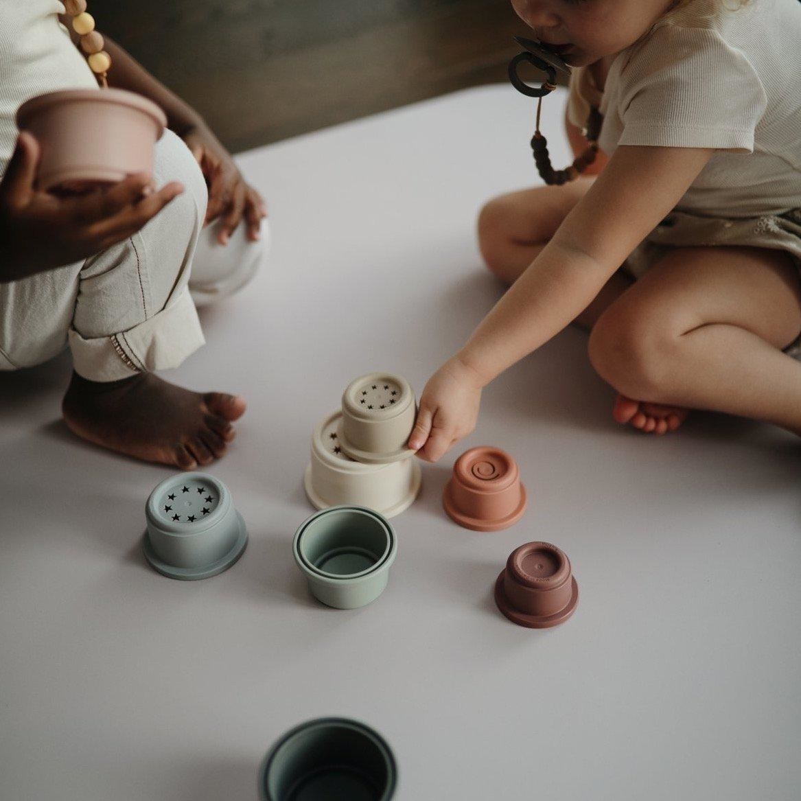 kids playing with the muted stacking cups