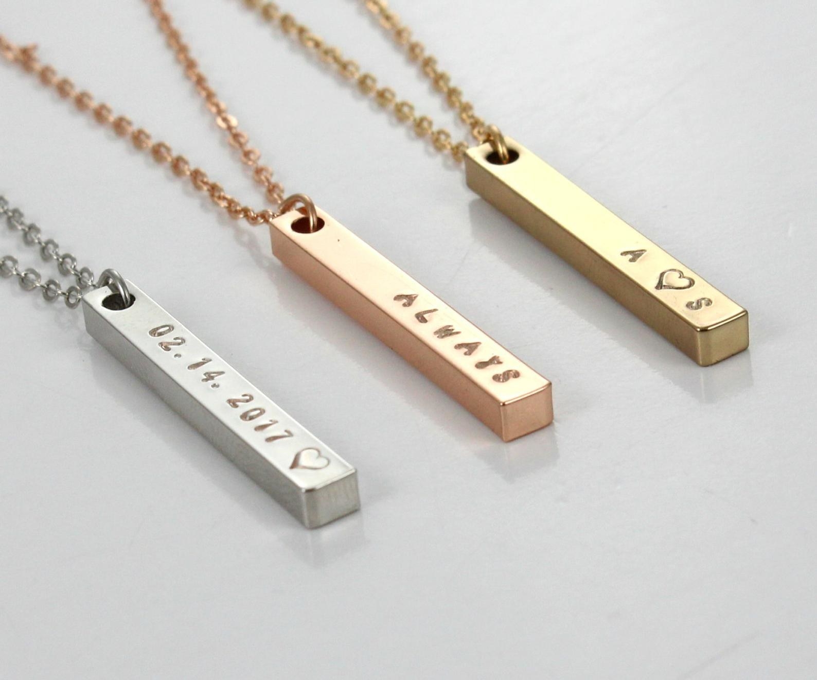 A silver necklace that says &quot;02.14.2017,&quot; a copper necklace that says &quot;ALWAYS,&quot; and a gold necklace that says &quot;A heart S&quot;