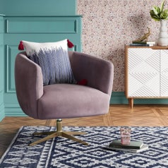 A mauve velvet accent chair with gold base