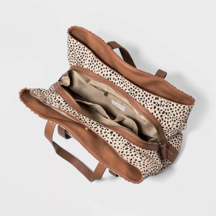 The tote in the color leopard print to show inner compartments of bag