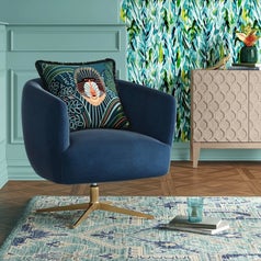 A navy velvet accent chair with gold base