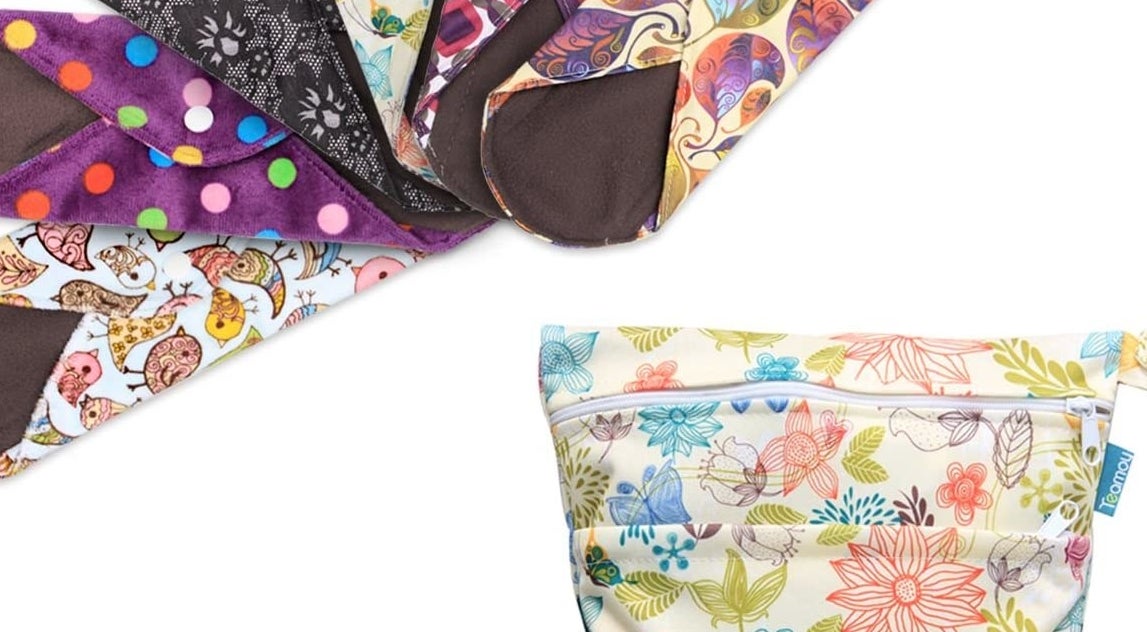 Bright patterned reusable menstrual pads with button clasps on their wings