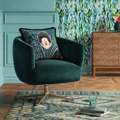 A dark green velvet accent chair with gold base