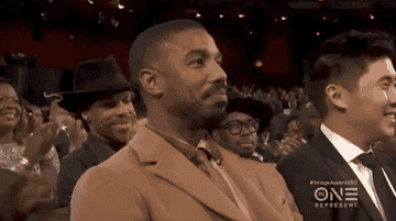Michael B Jordan smiles bashfully at the NAACP Image Awards