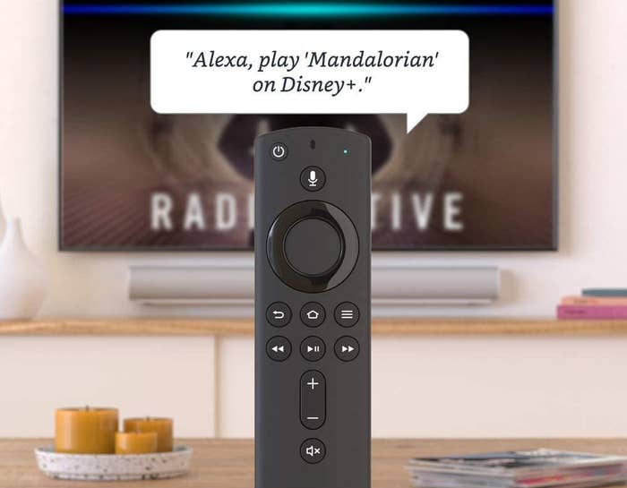 the fire stick's remote with the caption "alexa, play mandelorian on Disney plus"
