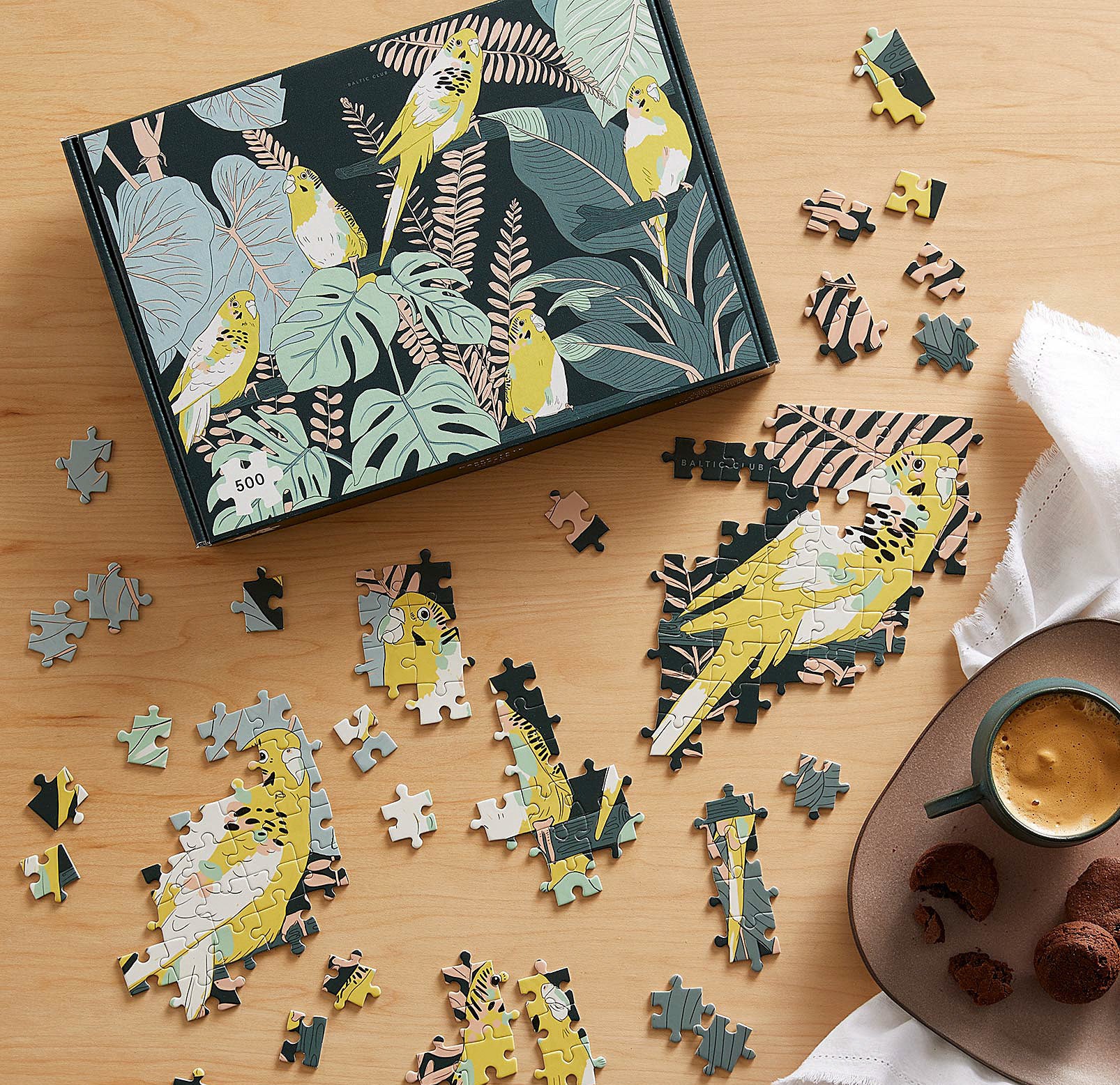 The puzzle being put together next to its box on a table