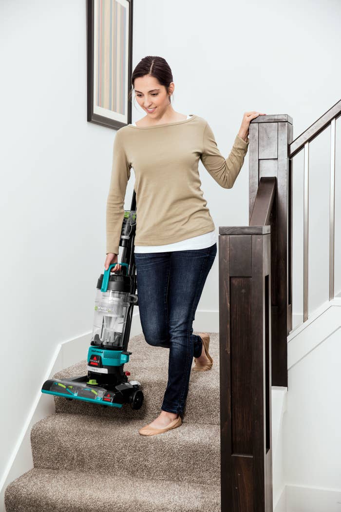 A model carrying the vacuum down a set of stairs