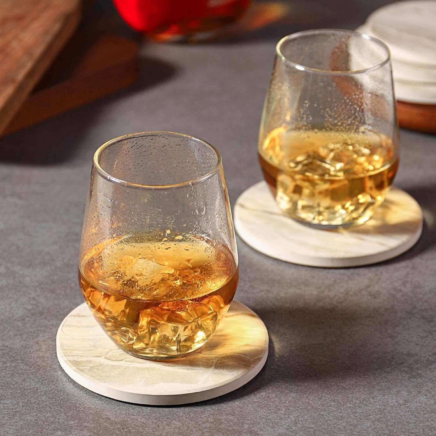 Two drinking glasses on coasters