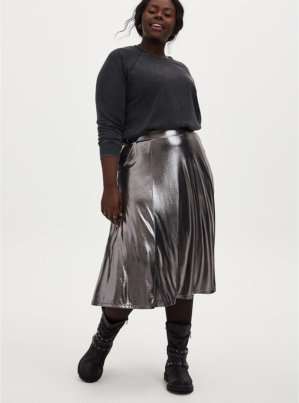 model wearing a silver metallic midi skirt