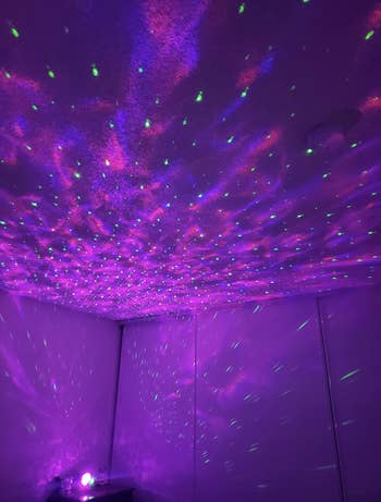 reviewer’s room with the ceiling and walls covered in purple stars from the projector