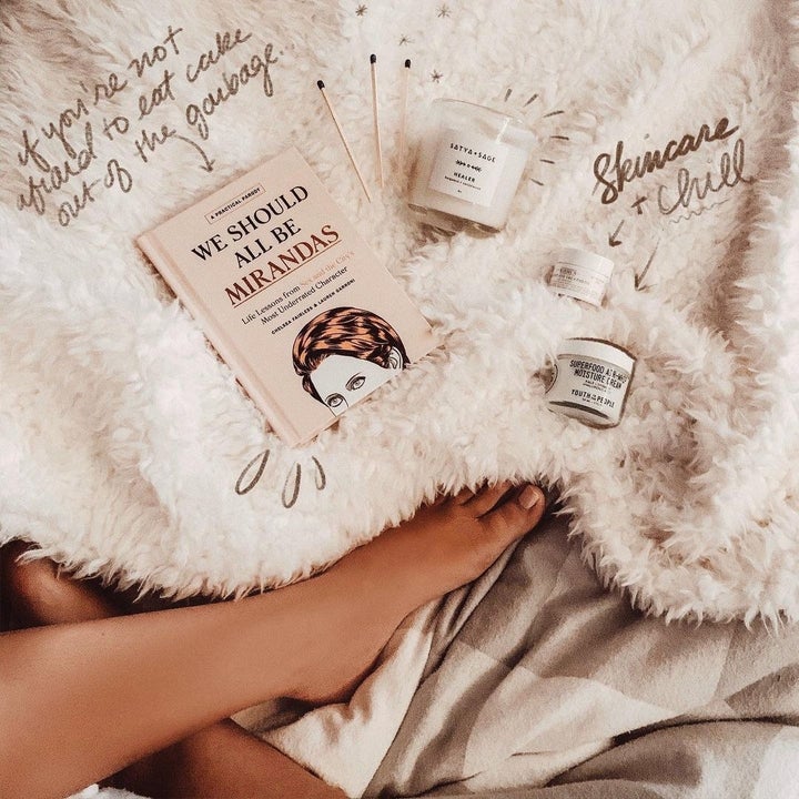 flatlay of skincare and we should all be mirandas book