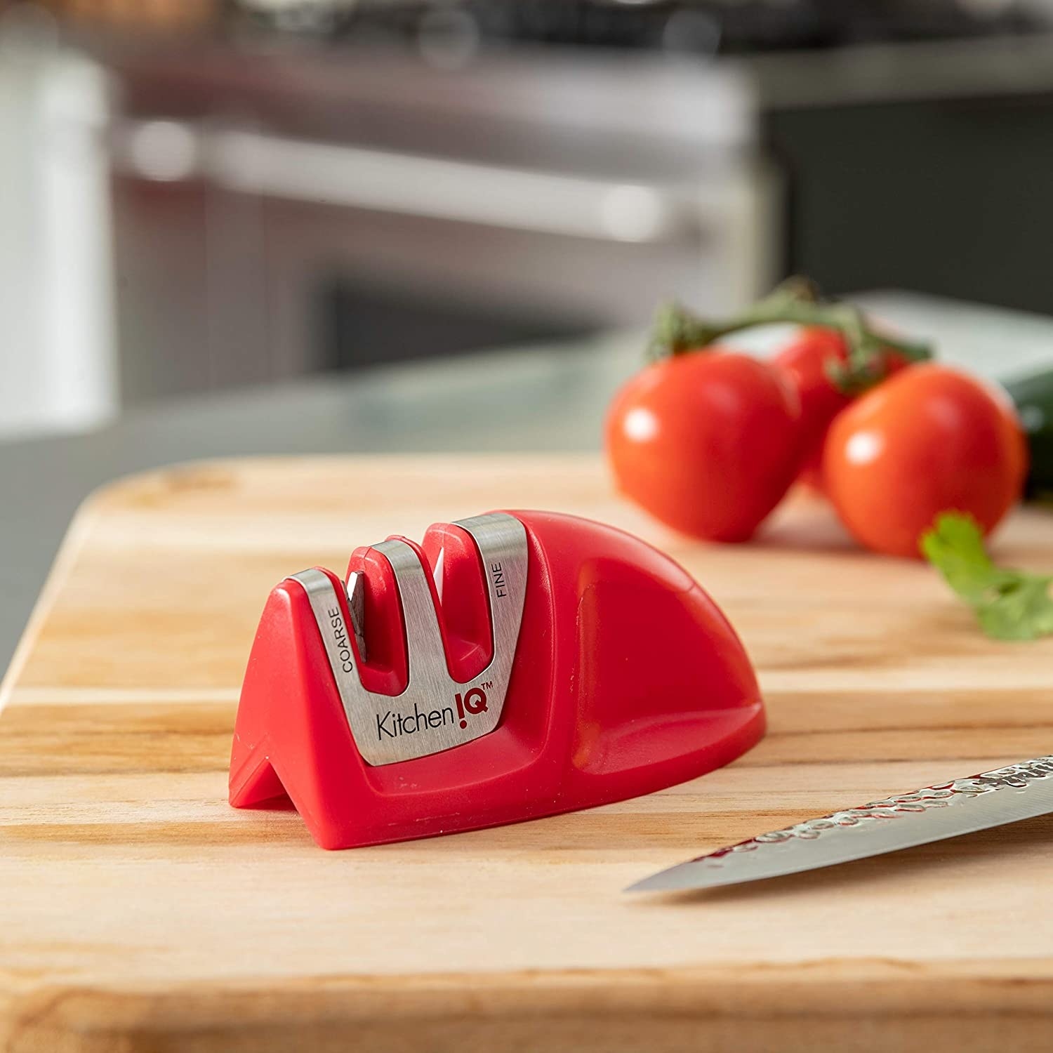red knife sharpener with two slots with metal inside for sharpening knifes