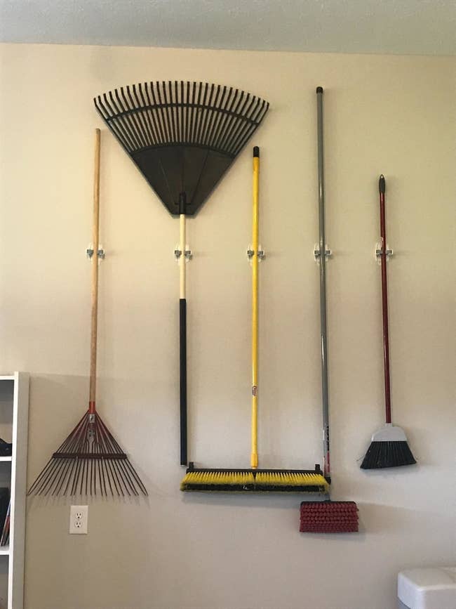 reviewer image of many brooms on wall
