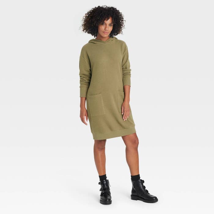 The model wearing the sweater dress