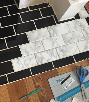 A reviewer's photo of them using the contact paper to refinish tile