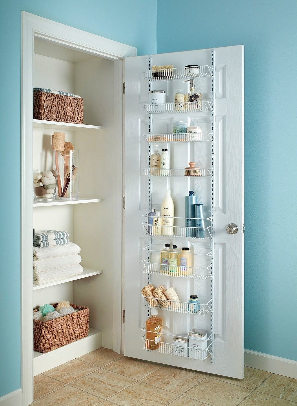 eight-shelf wire rack on the back of a bathroom door, storing all sorts of soaps, sponges, and more