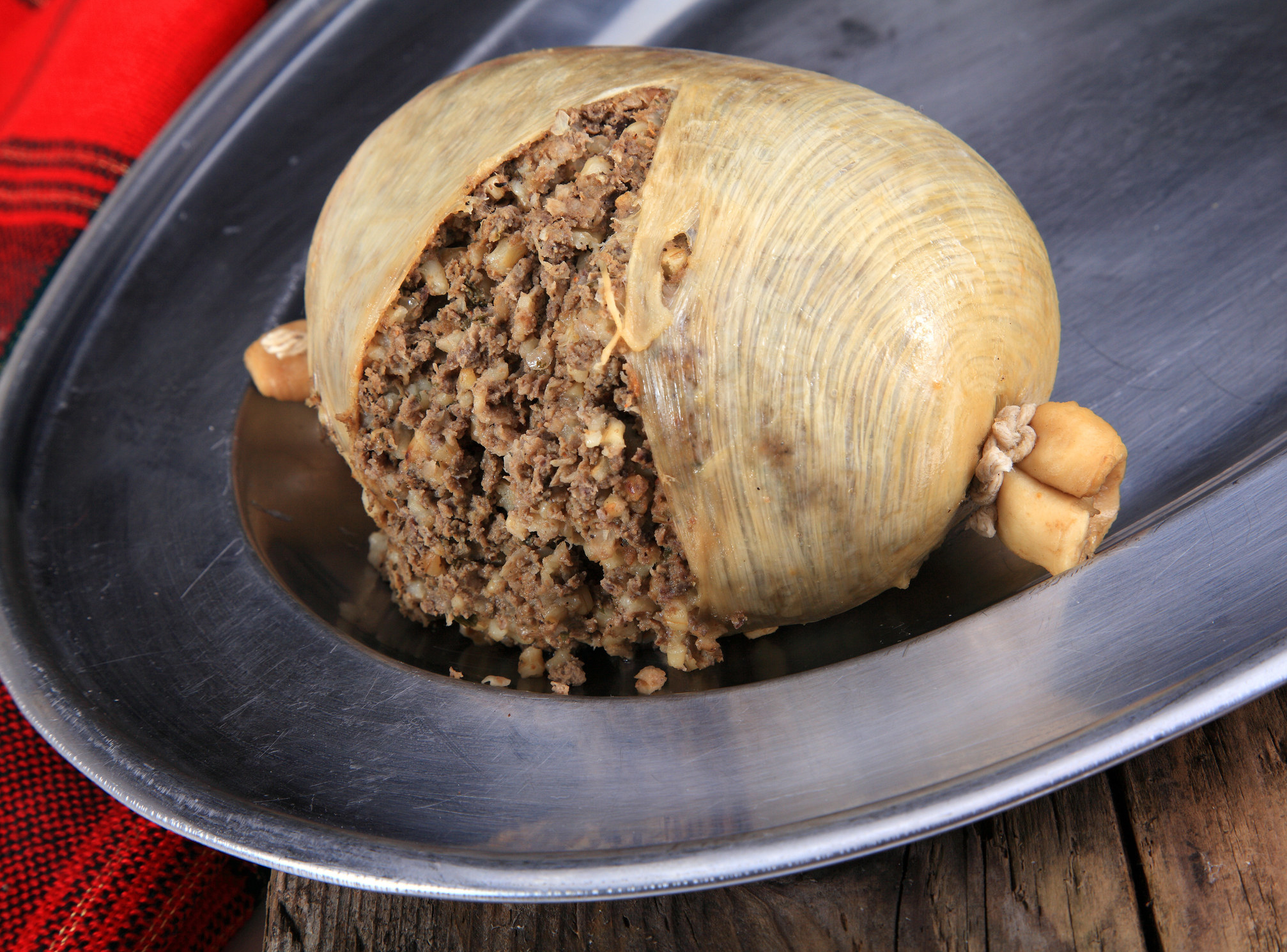 ground beef-like sausage spilling out of its casing