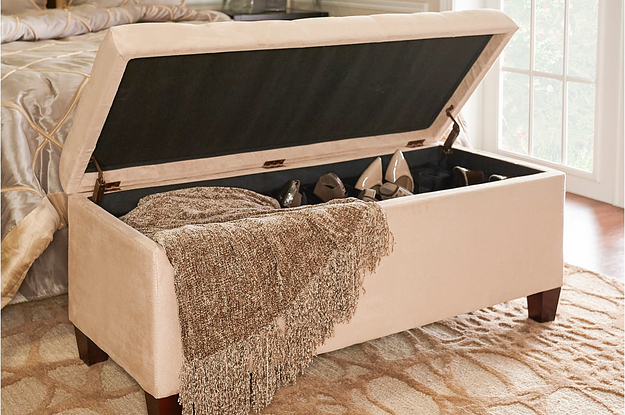 the storage ottoman with a blanket and shoes inside