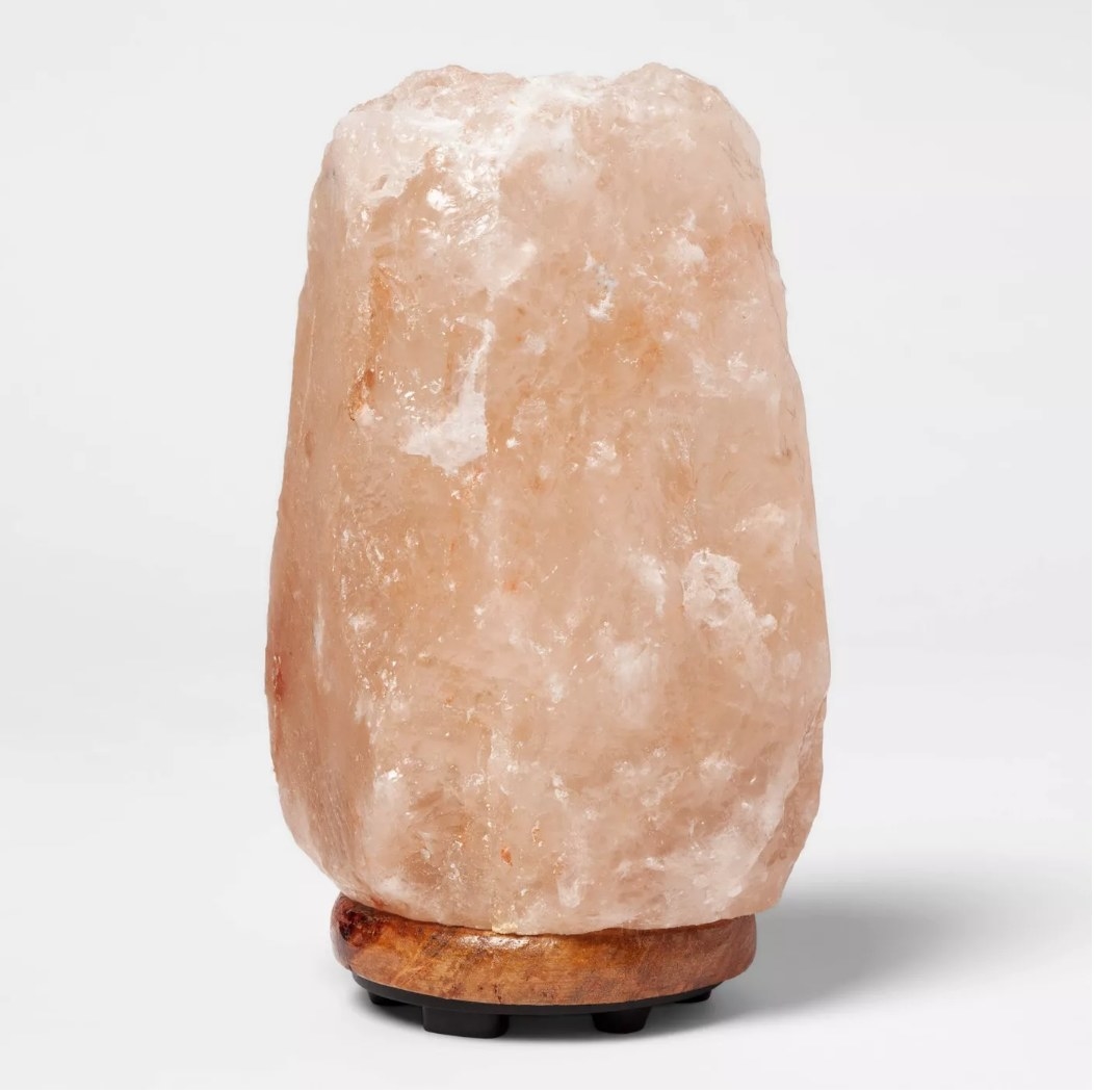 Pink salt lamp with wooden base