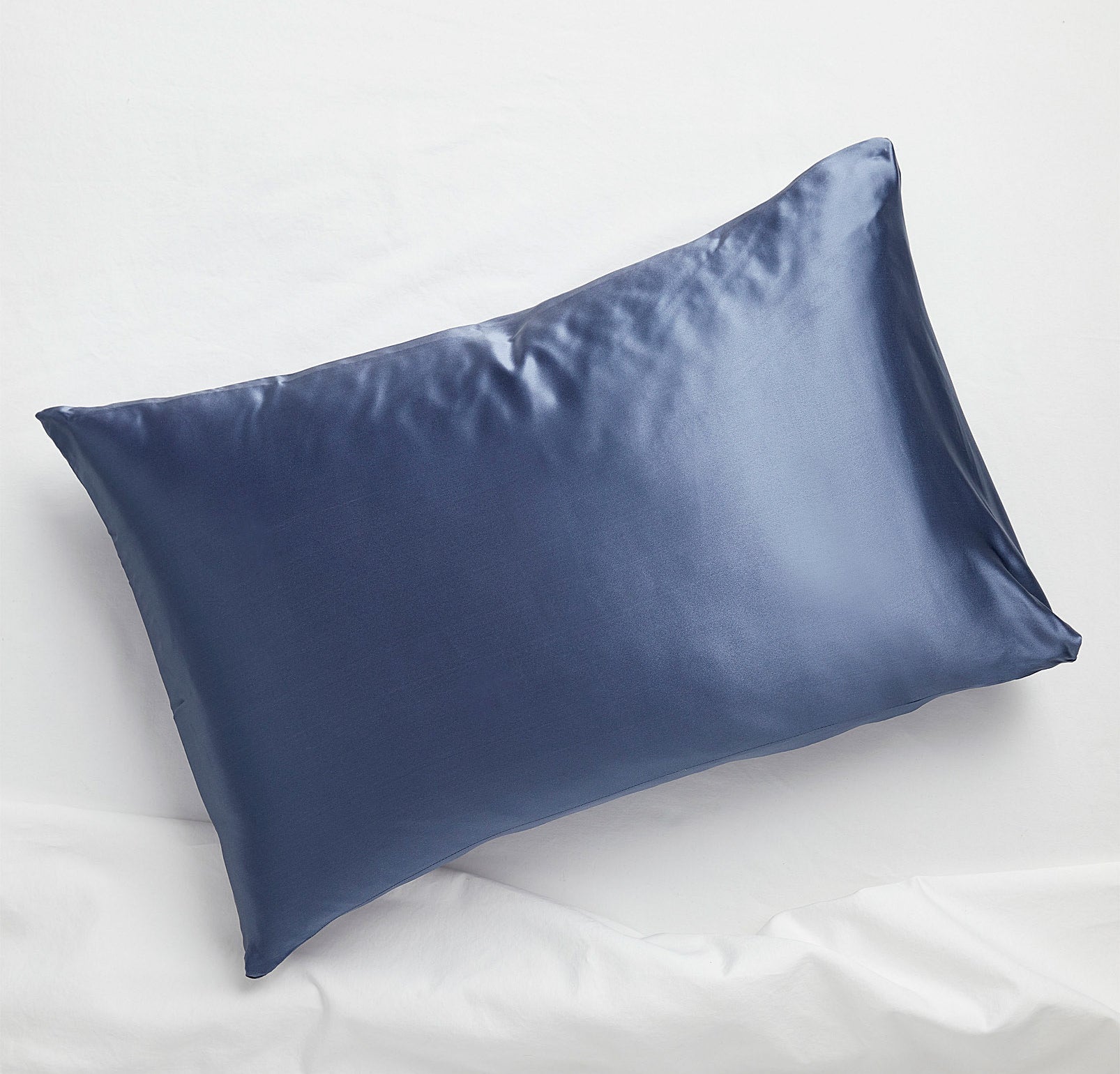 A silk pillowcase on a pillow on a bed