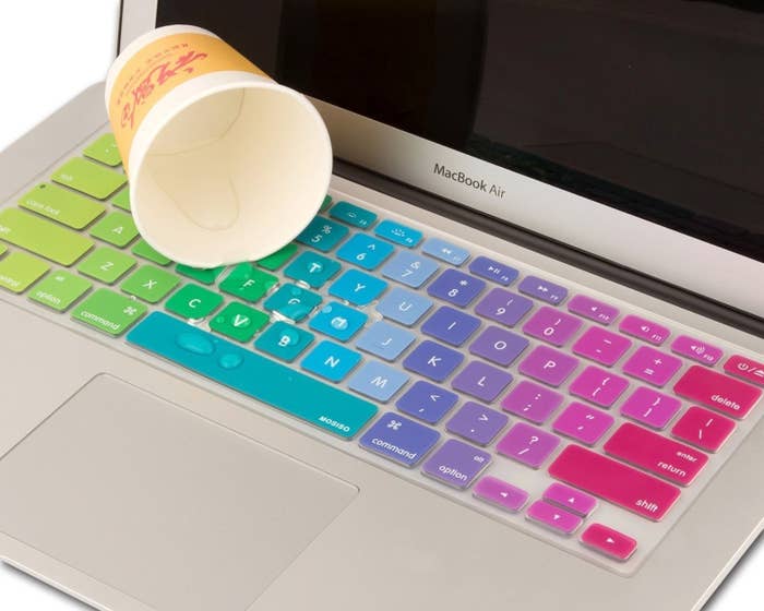 A rainbow keyboard cover with water spilled on it 