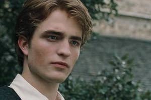 Cedric Diggory staring with a handsome yet slightly worried expression 