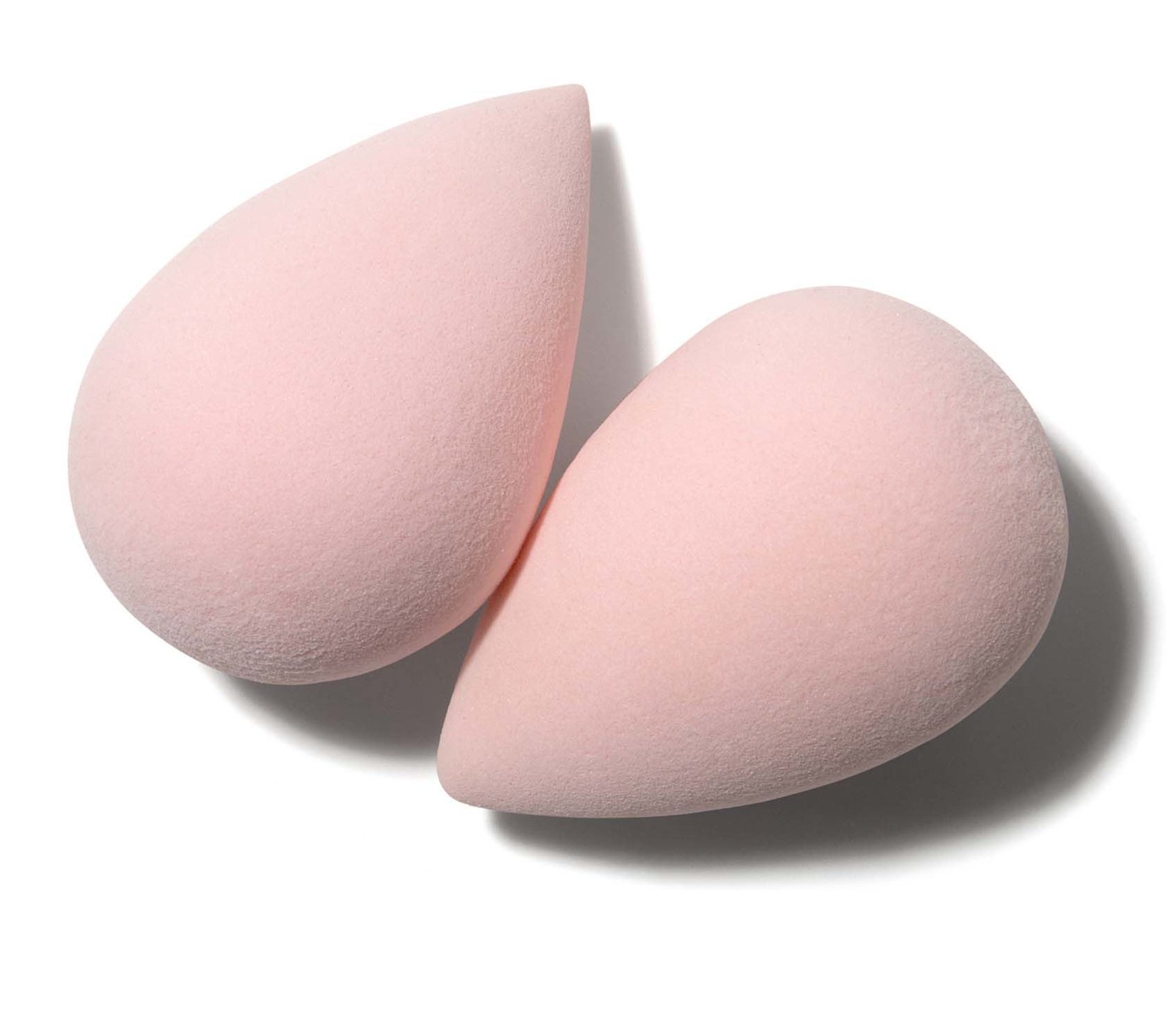 Two pink sponges on white background