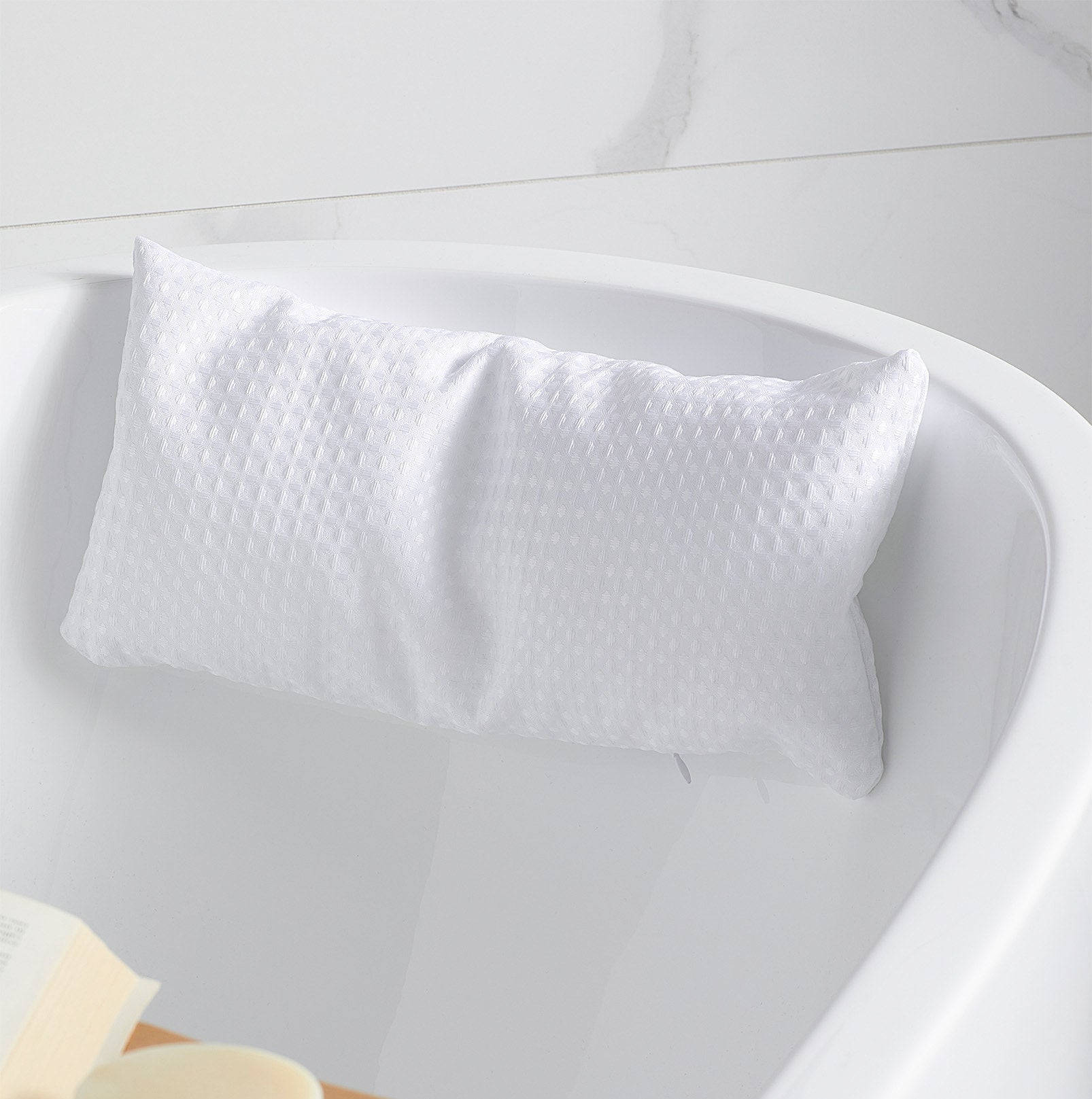The pillow attached to the back of the bath tub