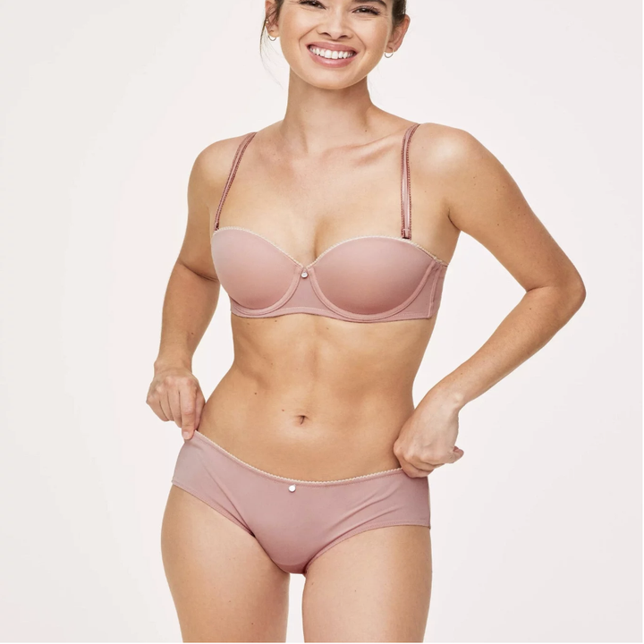 Model in pink shelf bra with straps and matching underwear