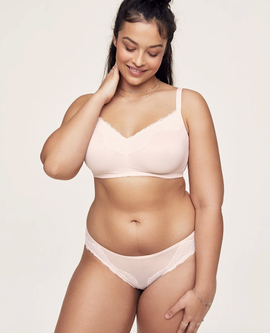 Model in light pink bralette with lace detail and matching underwear 