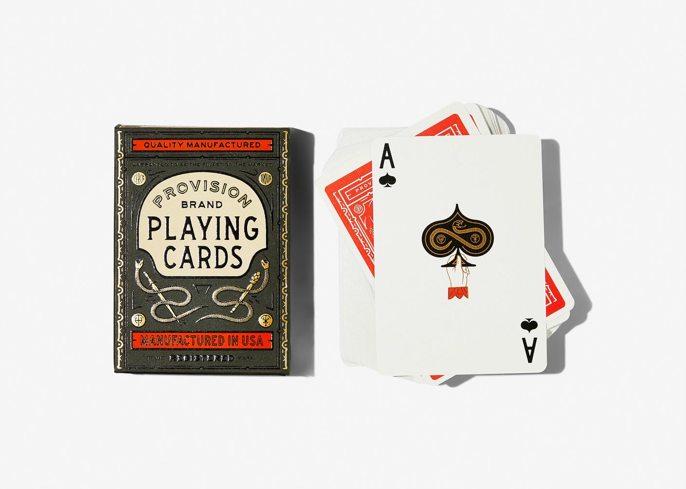 ace of spades that has illustration of hand holding spade with snake on it next to the pack that has vintage-style design 