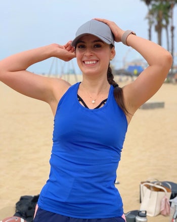 reviewer wearing the tight tank in blue
