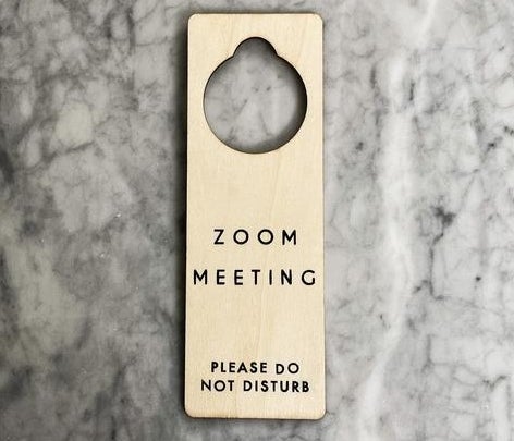 A natural wood doorknob hanging sign that says &quot;Zoom Meeting, please do not disturb&quot; in simple black letters&quot; 
