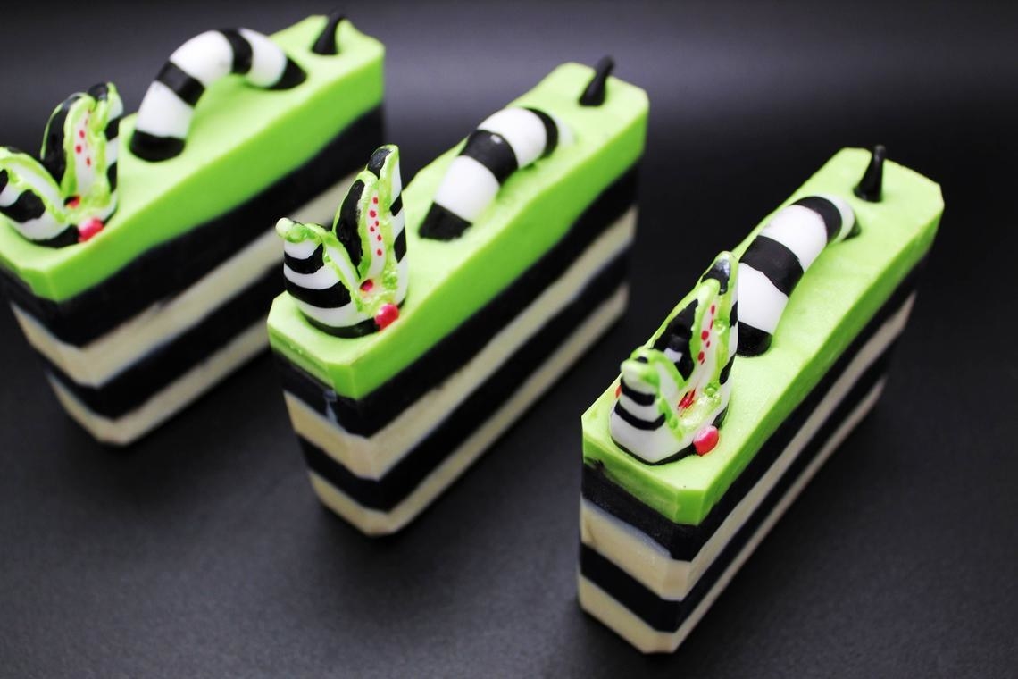 black and white striped soap with green top layer and sandworm coming out of the top 