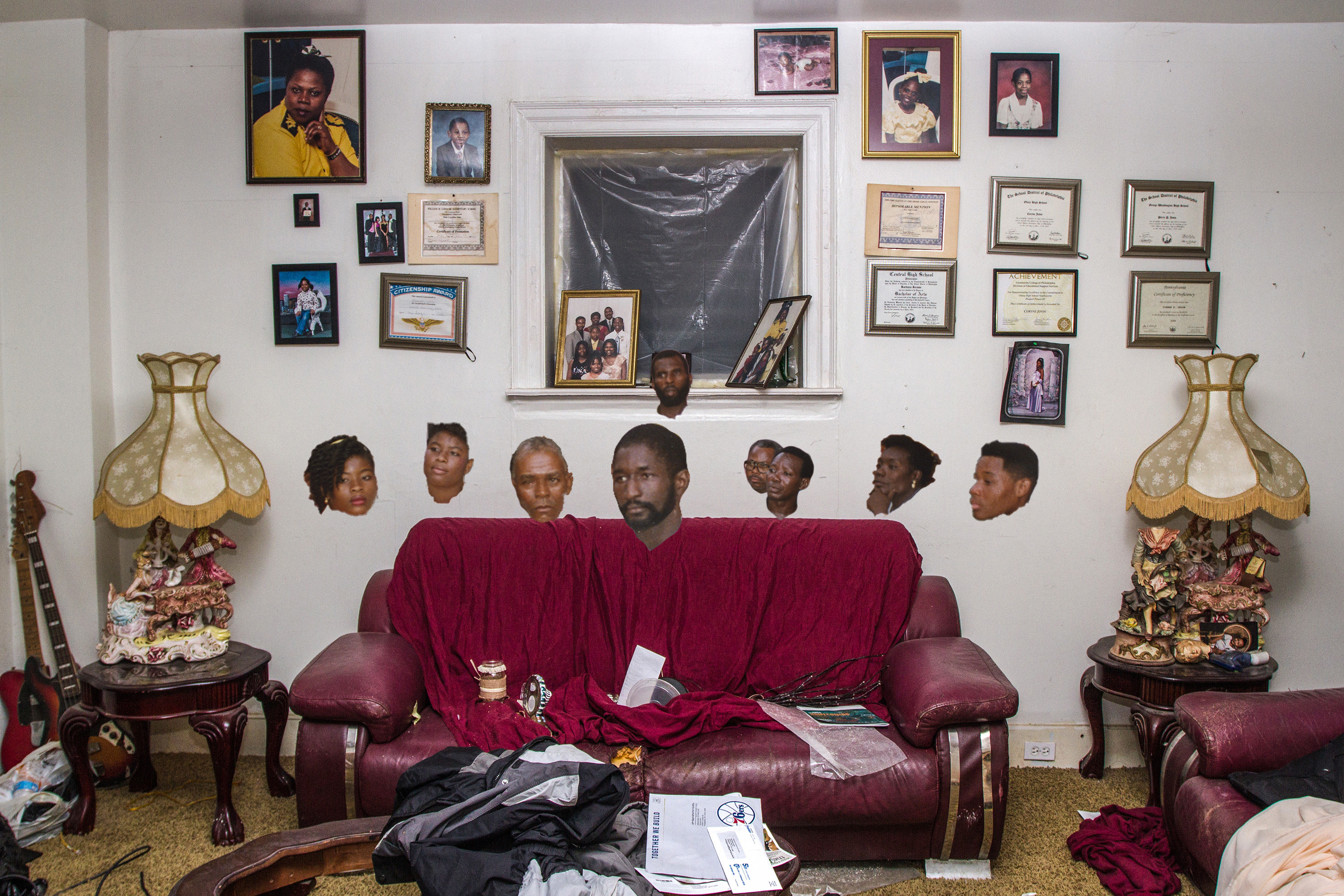 A collage of heads with no bodies hovering over a couch in a living room with pictures on the walls