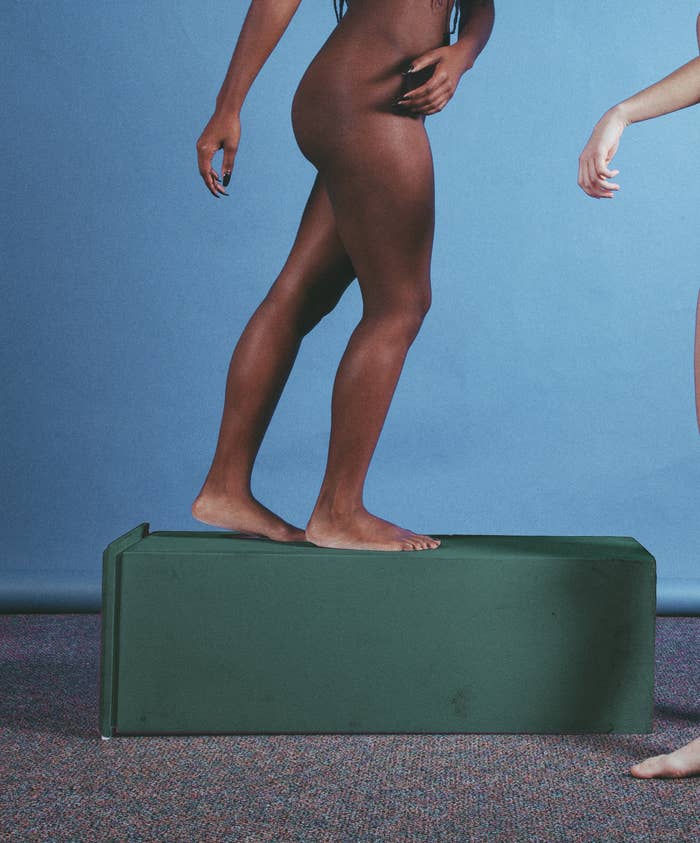 The lower half of a woman walking naked on a fallen pedestal 