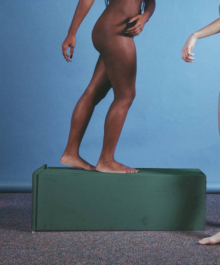The lower half of a woman walking naked on a fallen pedestal