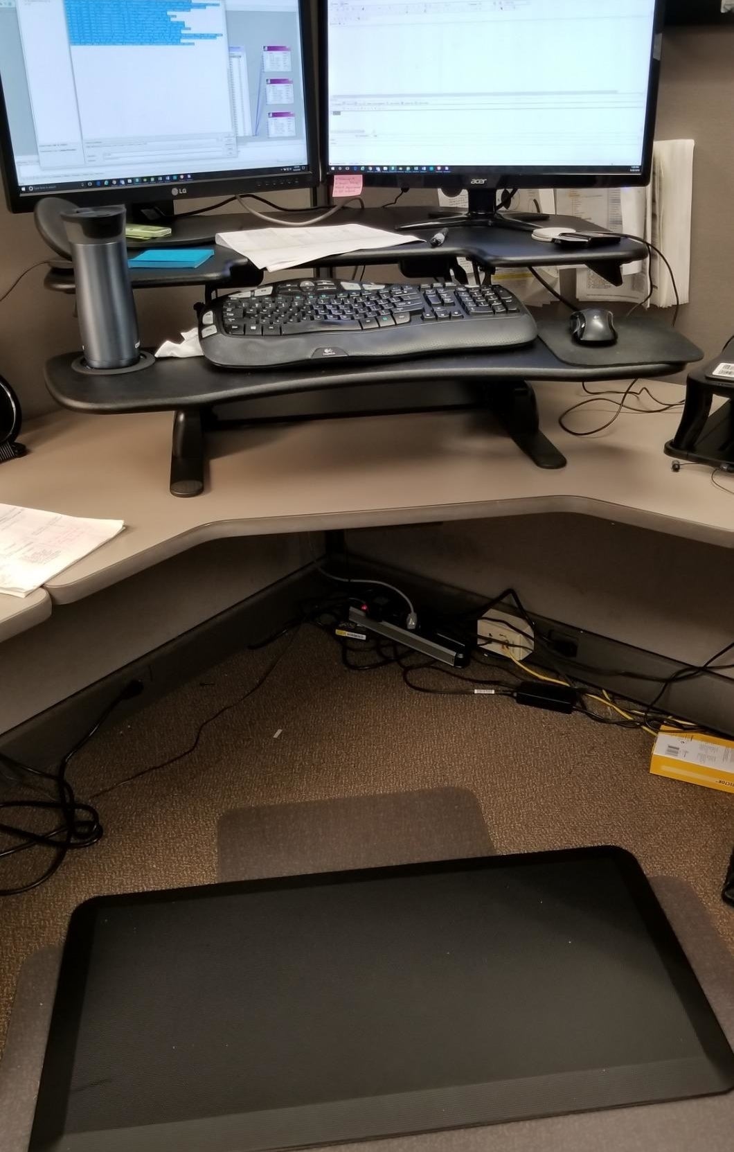 reviewer image of the sky solutions anti fatigue mat in front of their standing desk