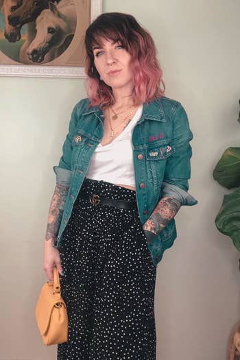A reviewer wearing the skirt in black with tiny polka-dots
