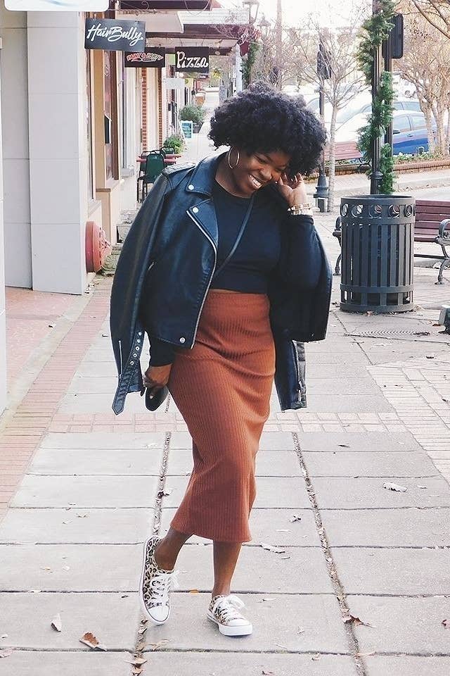 A reviewer wearing the skirt in brown
