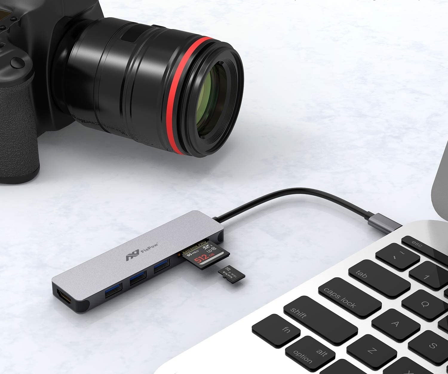 adapter connected into a laptop with an SD card in it next to a camera