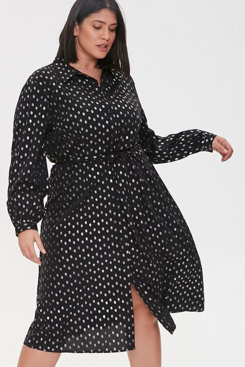 model wearing the knee-length shirt dress with tie waist in black with gold polka dots