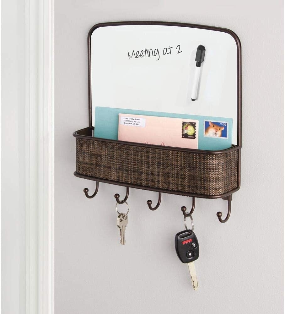 wall-mounted bronze organizer with dry erase board, basket, and five hooks