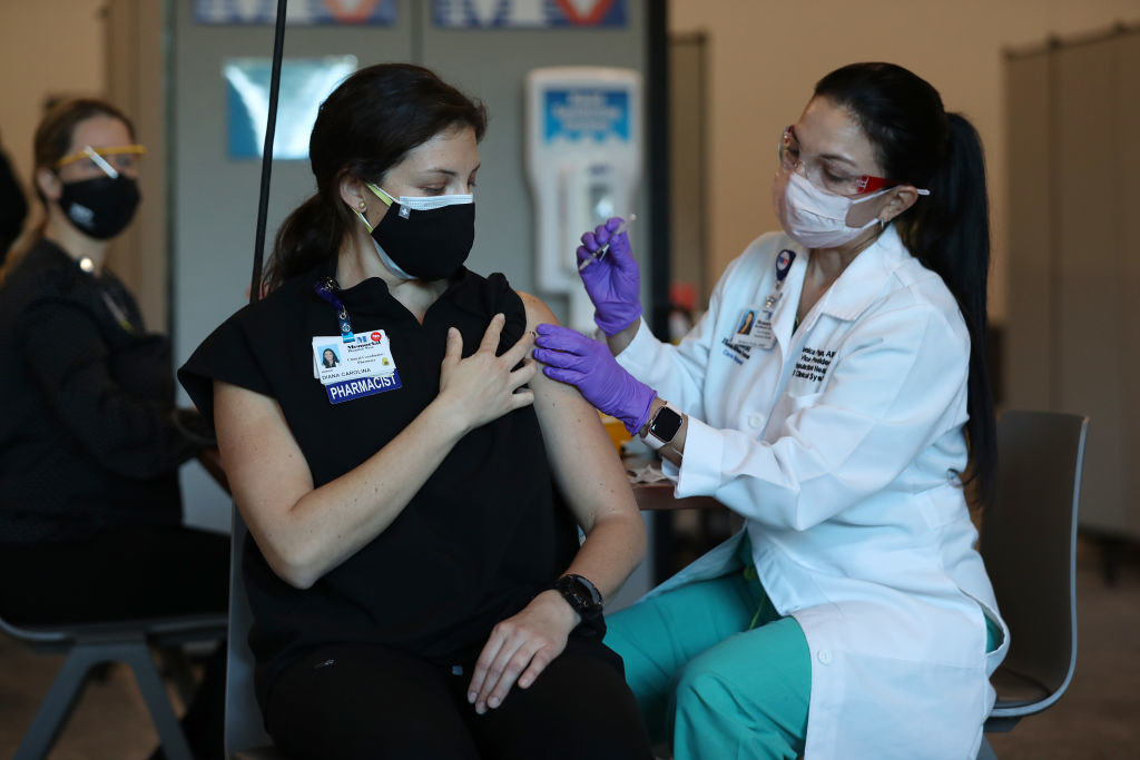 A healthcare worker receiving the vaccine