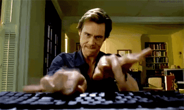 A gif of Jim Carrey in &quot;Bruce Almighty&quot; typing quickly on a keyboard 